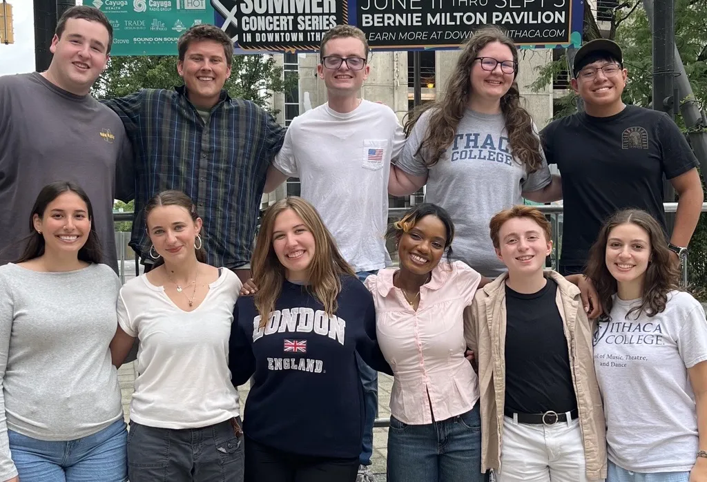 11 students smiling at the camera
