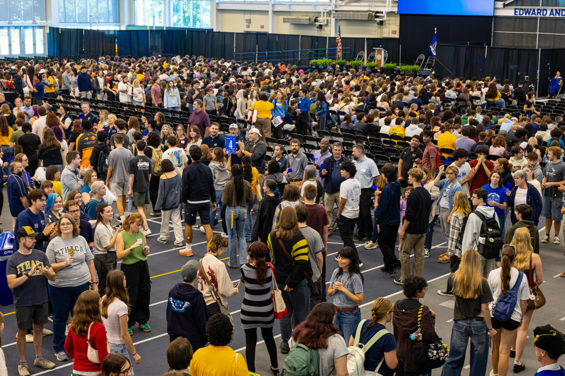 Hundreds of students pack an indoor arena.