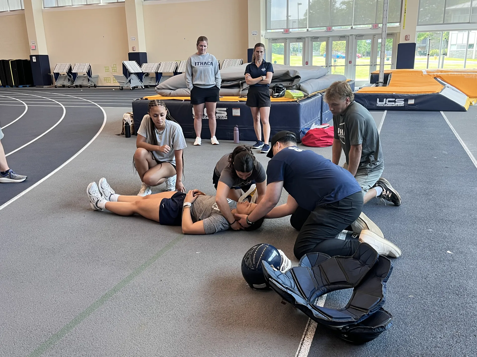 Students practicing removing football gears