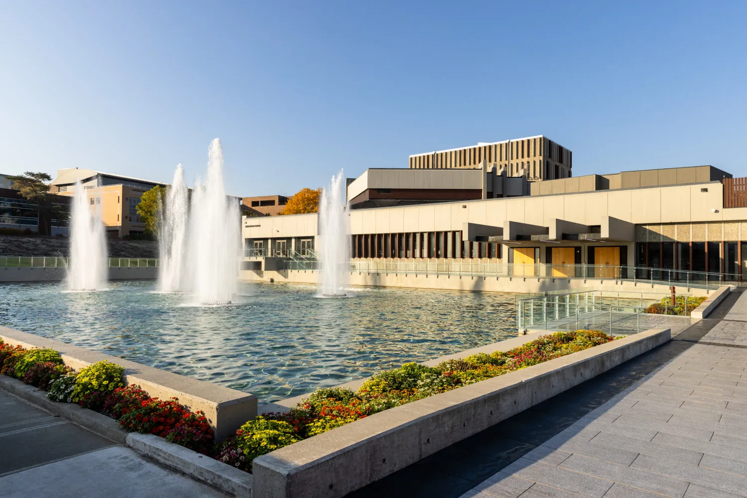 A building on a college campus with fountains.