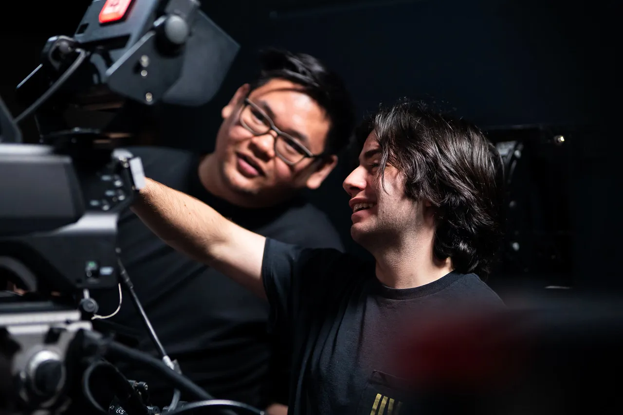 Students discuss the image on a television studio camera