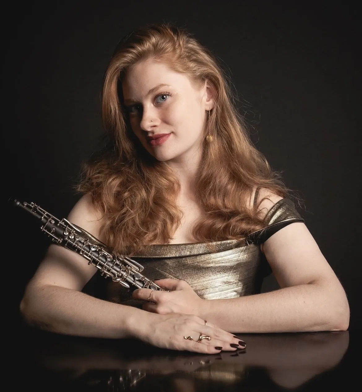 Oboe Professor Megan Wojtyla Headshot, oboe in hand