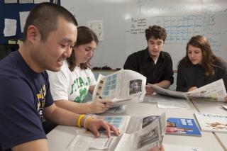 Students working on a newspaper assignment
