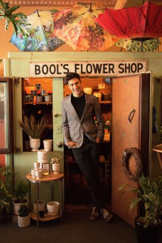 A man posing in a flower shop