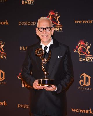 man with Emmy statue