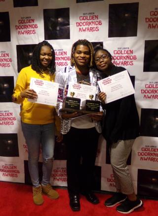 Three young women posing with awards