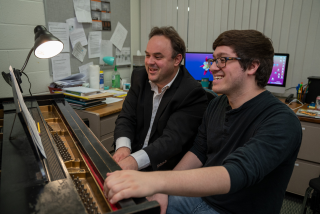 Student and Professor at piano during a lesson.