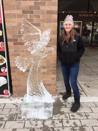student next to ice sculpture