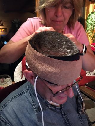 woman putting sensors on a man's head