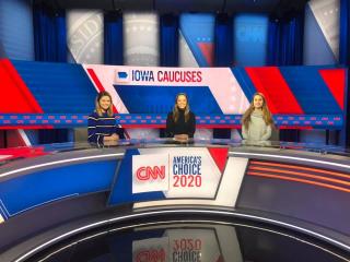 Three IC students at a news desk reporting on the 2020 primary