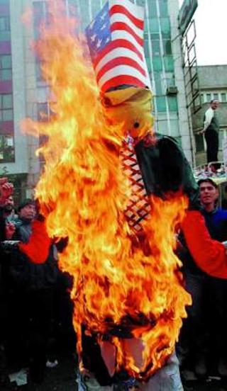 Photo of a burning effigy of George W. Bush