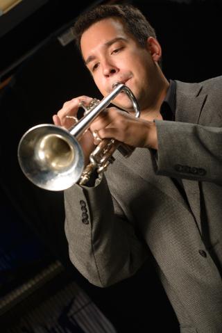 Picture of person in suit playing trumpet