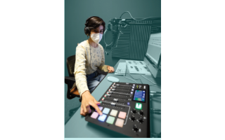 A student working at a mixing board
