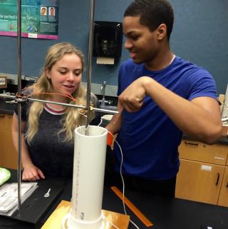 Two students work on a thermodynamics lab.