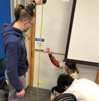 Students measure bounciness of a ball.