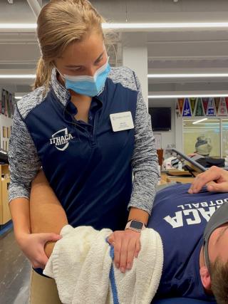 AT student providing care to an athlete in the clinic