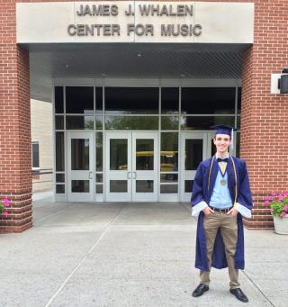 Bradley Whittemore poses in graduation cap and gown