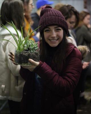 IC Student holds succulent plant.