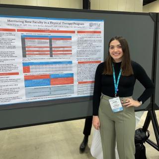 PT student in front of a poster at a national conference