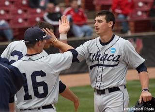 Tim Locastro high fives a baseball teammate 