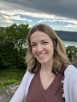 Woman outside on a cloudy day smiling
