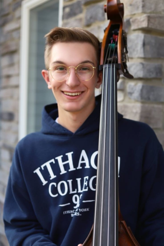 man with Ithaca College sweatshirt holding double bass