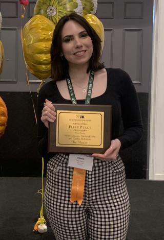 Alexis Manore ’22 holding an award