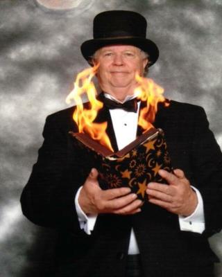Man in a suit holding a book on fire