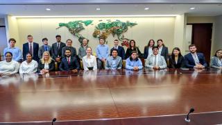 IC students and faculty at BlackRock’s conference room with Adrian Guenther ‘07