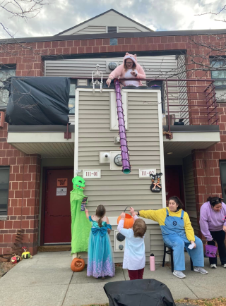 Children standing underneath a candy chute