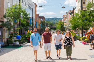a small group of students walks through the Ithaca Commons
