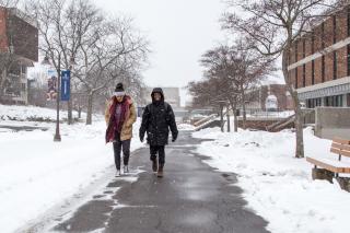 Image of Two Students Walking on Academic Row on Snowy Winter Day