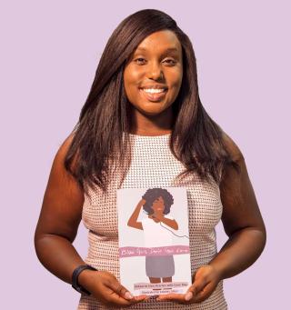 Image of Eden Strachan holding her book "Black Girls Don't Get Love"