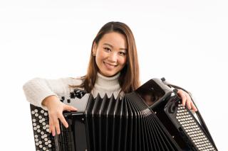 a woman holding an accordion