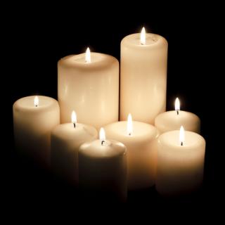 Lit candles against a dark background.