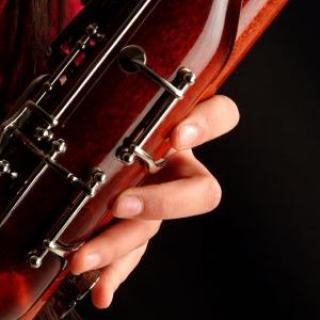 Closeup of fingers on a bassoon.