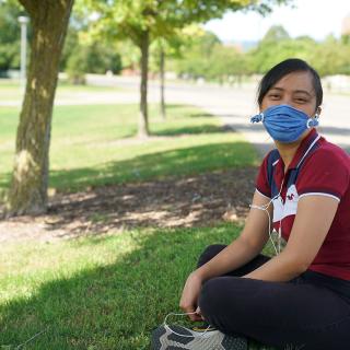student wearing a mask on the quad