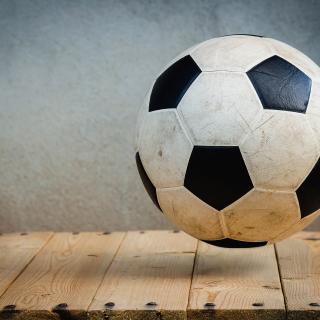 Soccerball on wood floor.