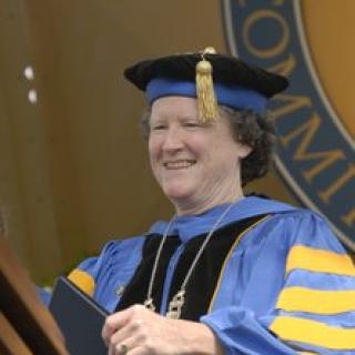 Woman in ceremonial academic cap and gown.