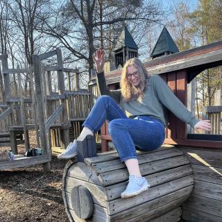 Woman on a playground smiling