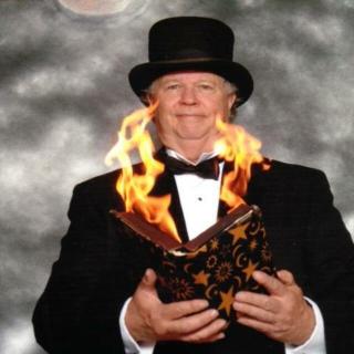Man in a suit with a book on fire