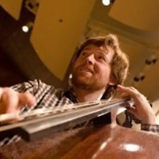 Caucasian male playing bass