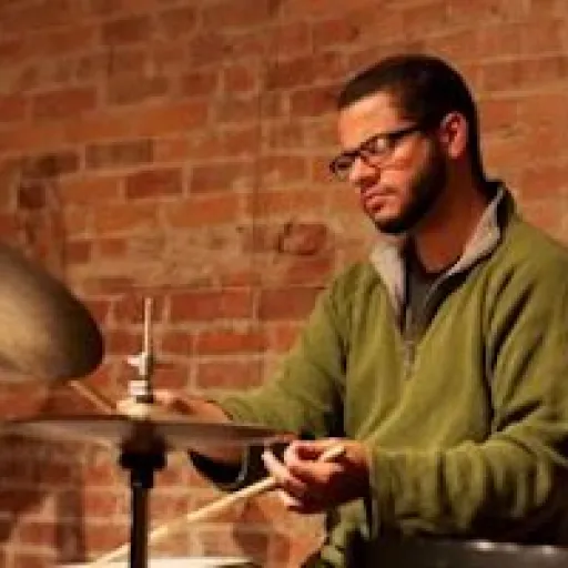 Caucasian male playing on a drum set