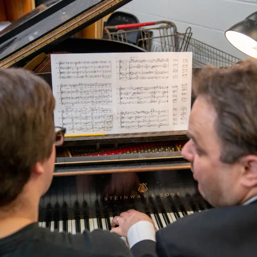 Student and professor with a piano