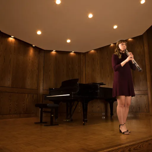 Student playing oboe on stage