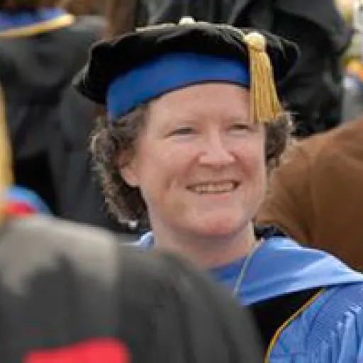 Woman in ceremonial academic cap and gown.