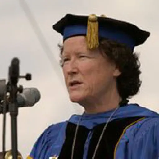 Woman in ceremonial academic cap and gown.