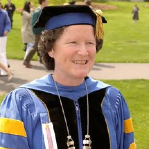 Woman in ceremonial academic cap and gown.