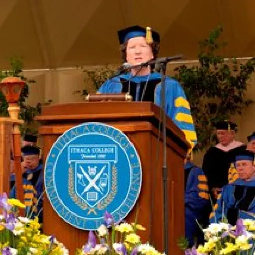 Woman in ceremonial academic cap and gown.