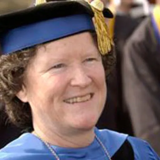 Woman in ceremonial academic cap and gown.